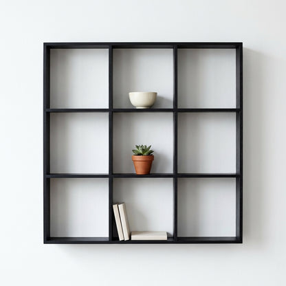 Prateleira-grelha Moss em pinho preto com nove nichos, montada na parede com peças decorativas